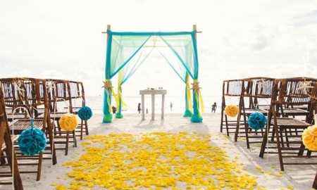 Wedding Beach Destinations: This is a Yellow and Turquoise Beach Wedding Ceremony Decor Idea. Check out more romantic beach wedding destinations on Worthminer.com