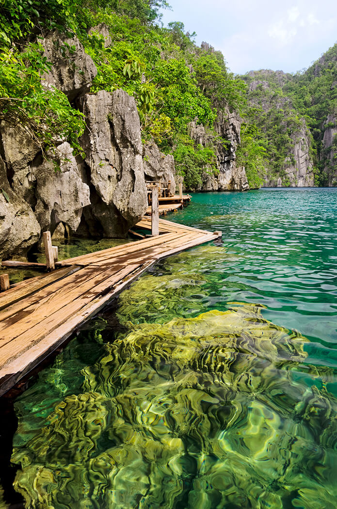 Kayangan lake on Coron Island surrounded by limestone cliffs is a popular tourist attraction at the Philippines